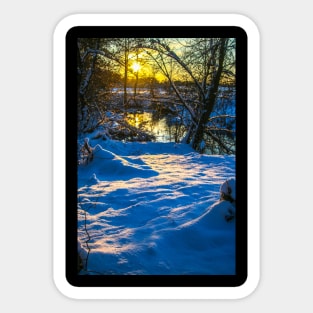 Snow falling on a river with snowy banks Sticker